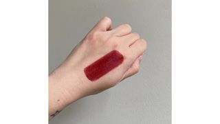 Swatch of Armani Beauty Lip Power 404 red lipstick