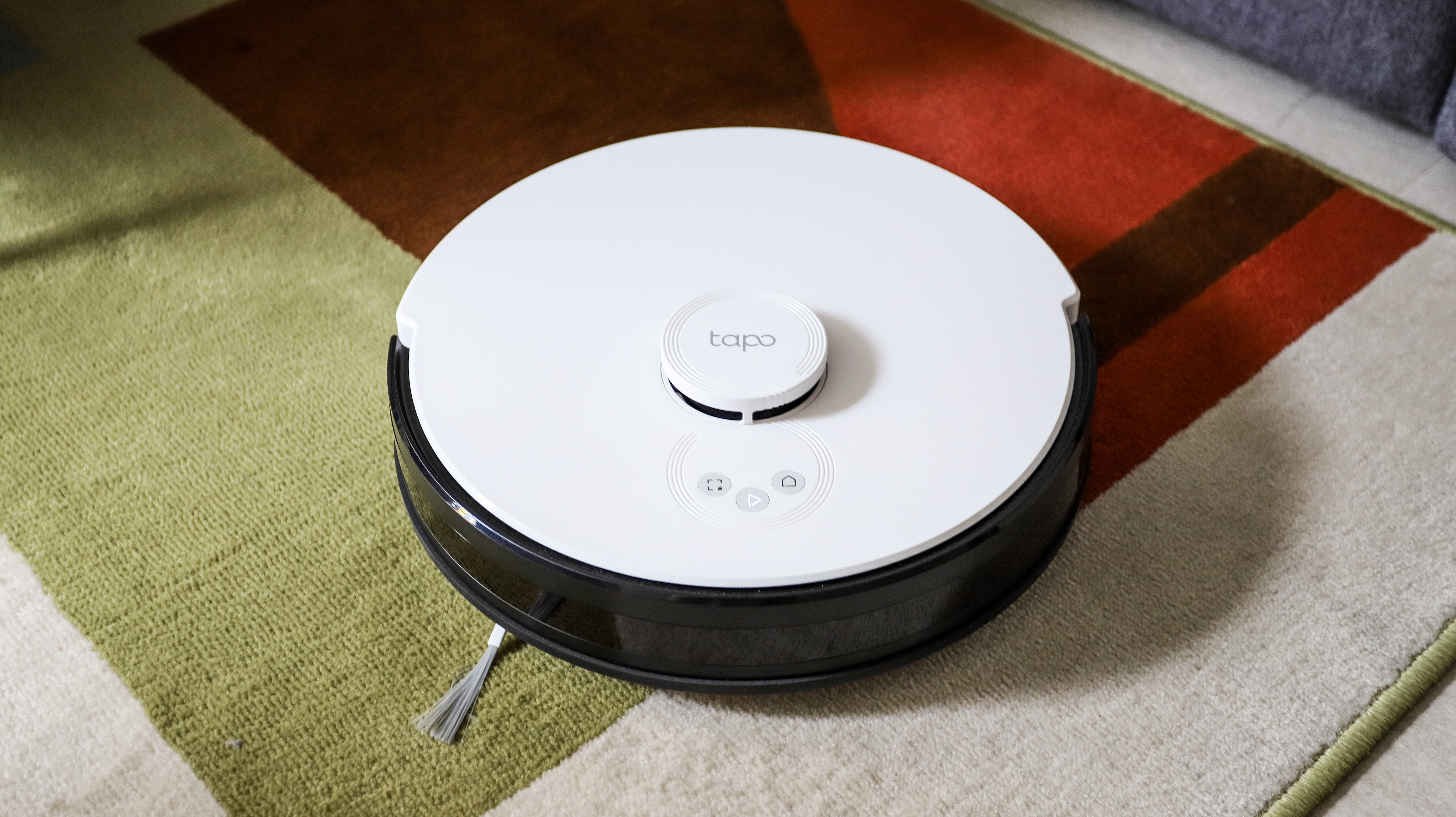 TP-Link Tapo RV30 Plus robot vacuum cleaner on a colorful carpet