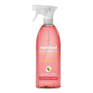 A clear plastic bottle Method Antibacterial All-Purpose Cleaner, Pink Grapefruit, with pink liquid, white text, and white spray lid