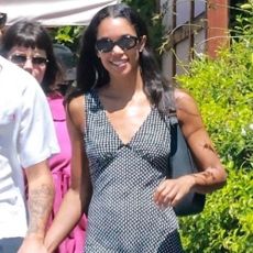 Laura Harrier wears a v-neck bias cut dress.