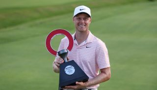 Cameron Davis holds the Rocket Mortgage Classic trophy