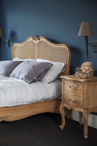 rattan bed in navy bedroom