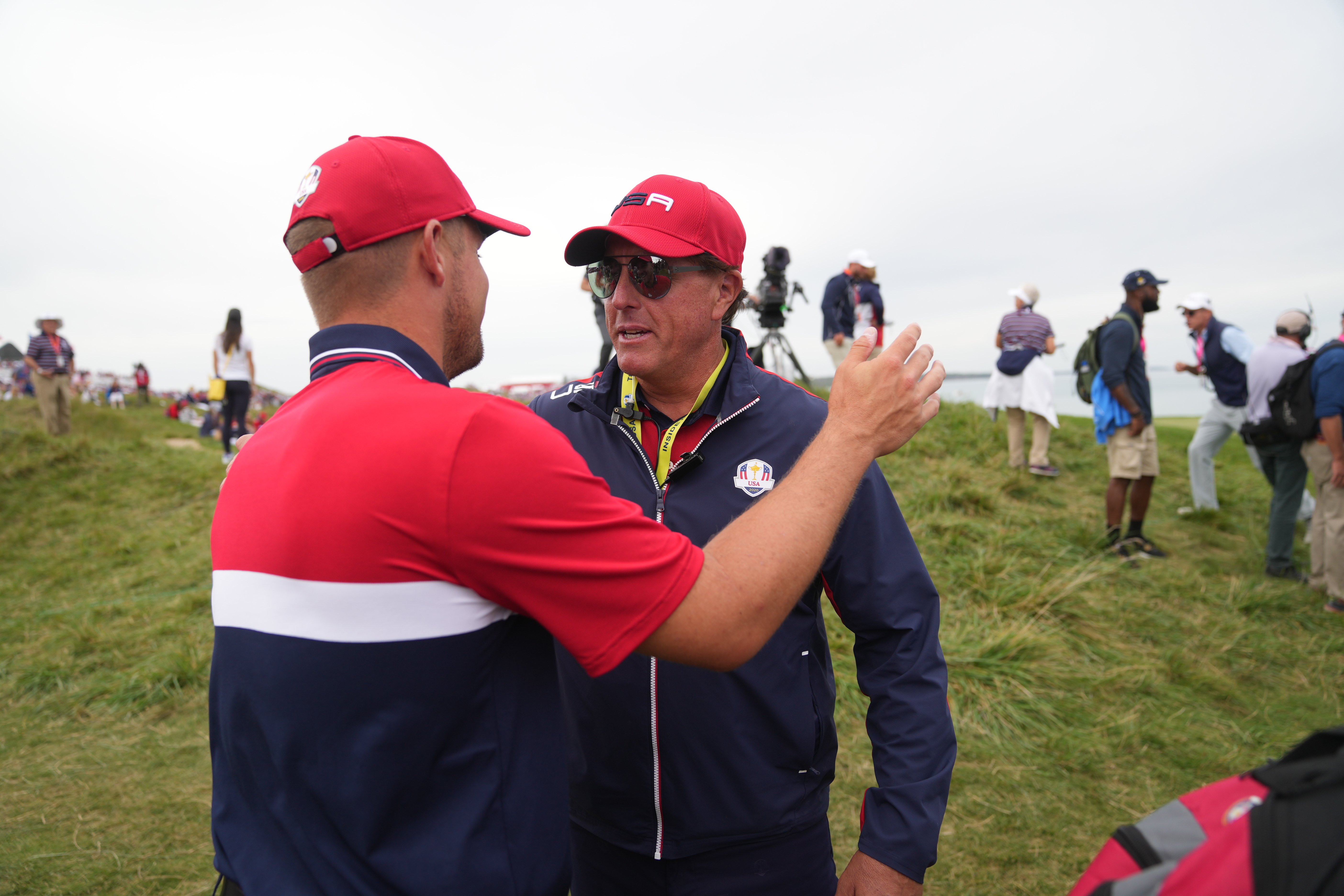 Phil Mickelson hugs Bryson DeChambeau