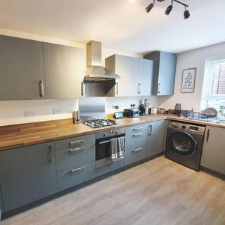 frenchic kitchen with unit doors with grey ones chimney and kitchen hub and wooden flooring