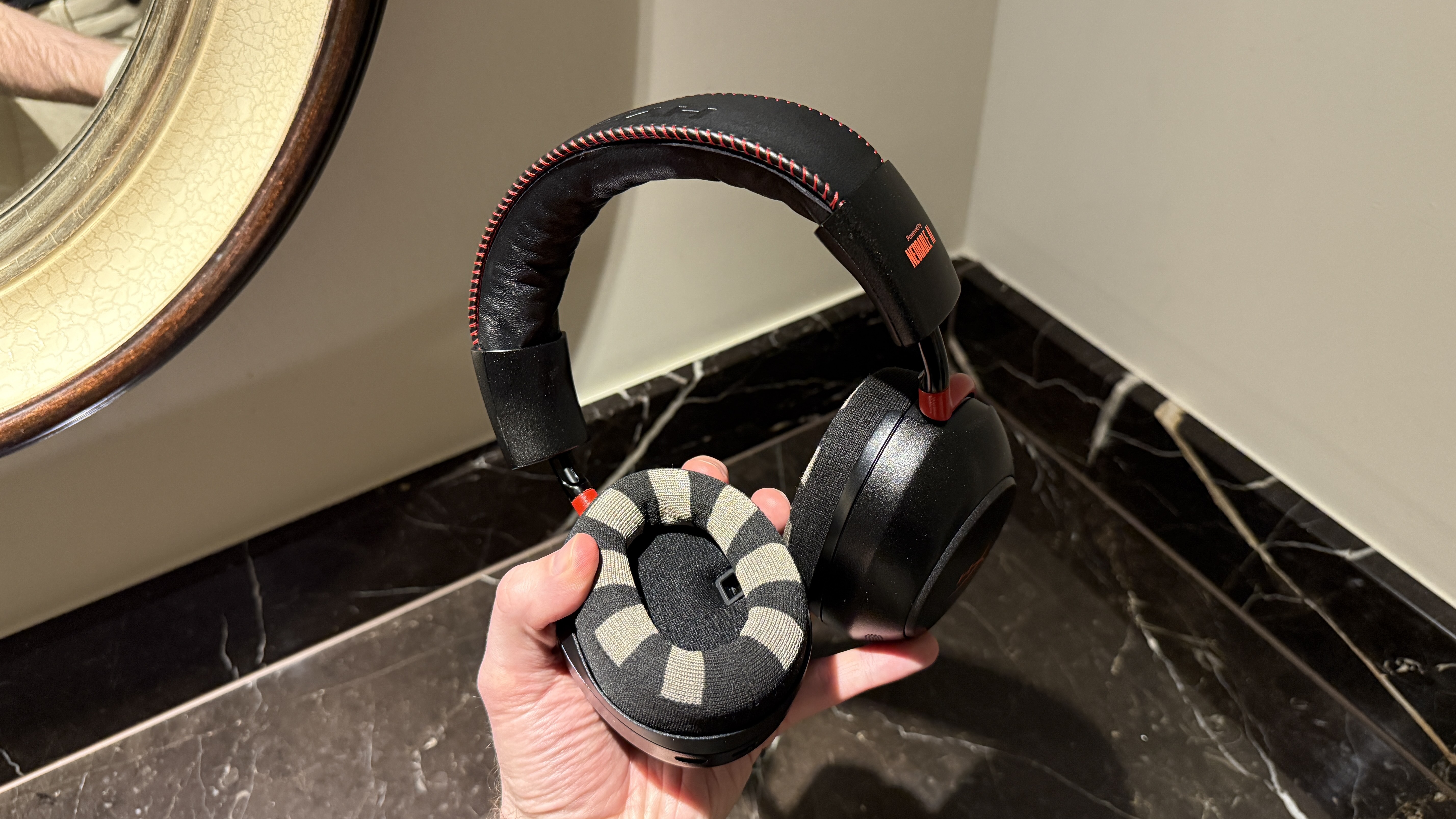 The HyperX Neurable prototype in a man's hand
