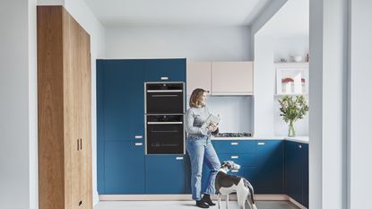 Dark blue kitchen in an open plan layout