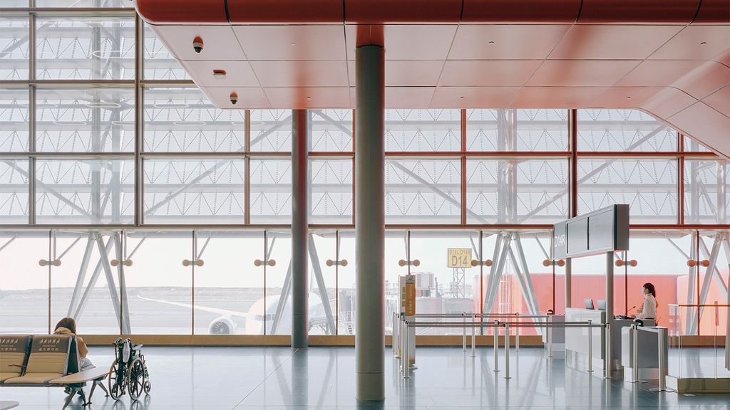 A white airport with orange ceilings
