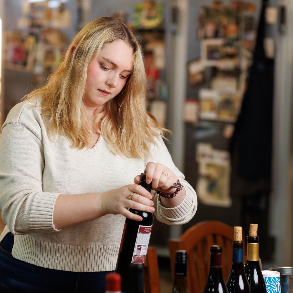 Au Bon Climat co-owner Isabelle Clendenen opening a lineup of bottles for a tasting