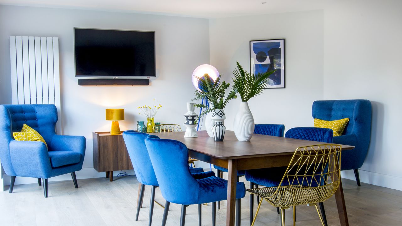 How to mount your TV to a wall Blue velvet dining room chairs in a dining room with wall mounted TV 