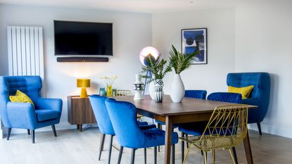 How to mount your TV to a wall Blue velvet dining room chairs in a dining room with wall mounted TV