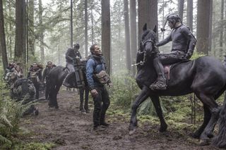 Jason Clarke and Andy Serkis (on horse) act in a scene from "Dawn of the Planet of the Apes." The sensors attached to Serkis help digital artists create his ape character Caesar on film.