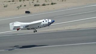 a small white space plane comes down for a landing at a runway in the desert