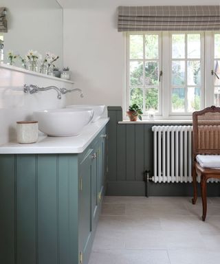 Green tongue and groove bathroom in country house in Wiltshire