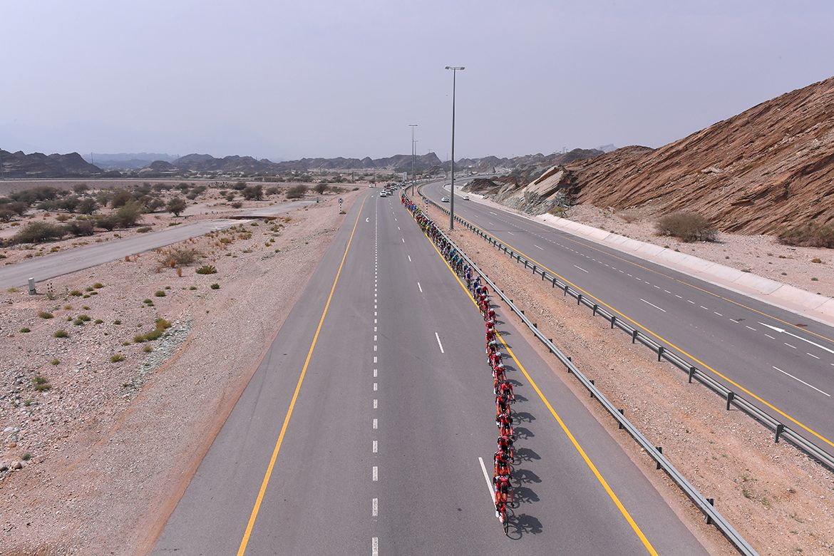 The peloton in single file under the pace set by BMC