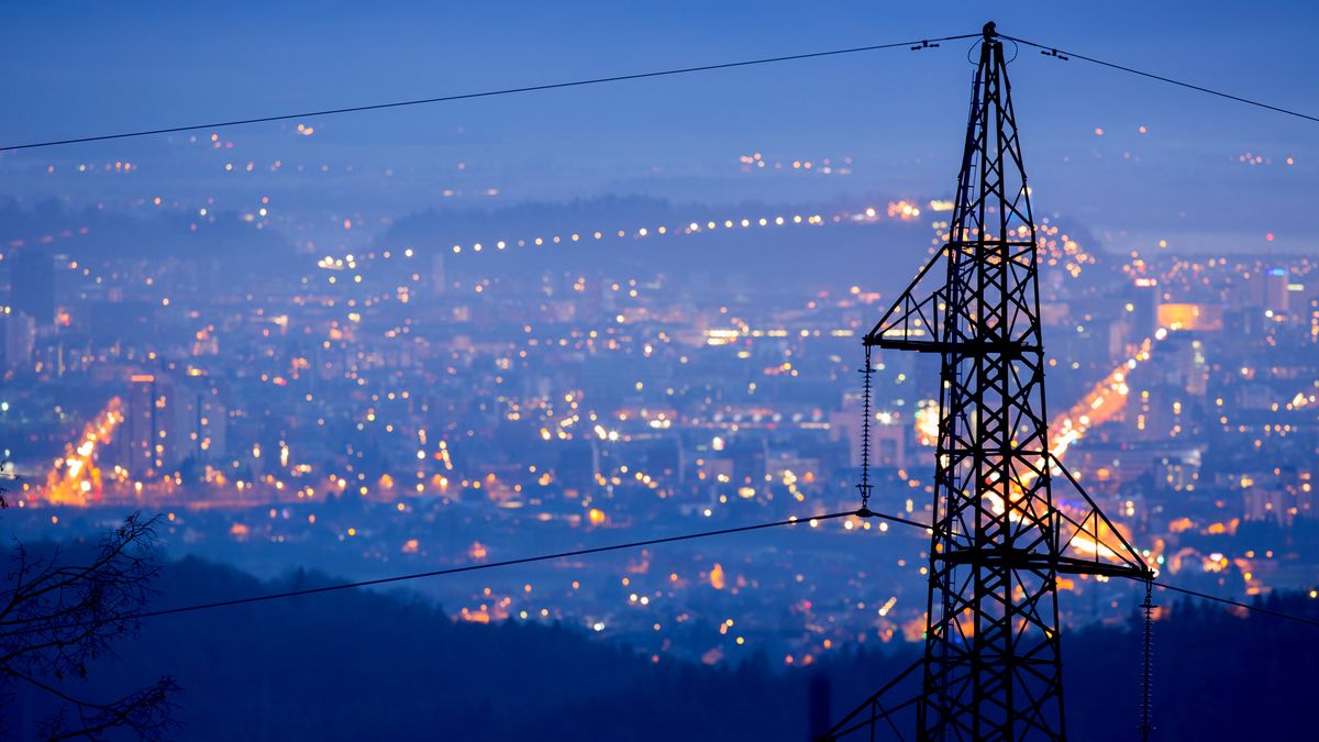 Power lines set against a city at night