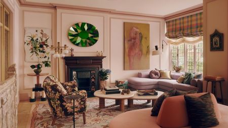 A contemporary living room, painted pink and with furniture and accessories from a mix of different eras