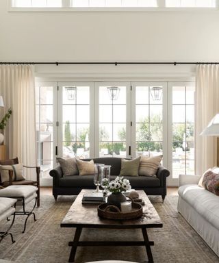 Grey sofa in a white living room with french doors