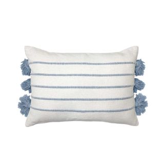 A white cushion with blue stripes and blue tassels