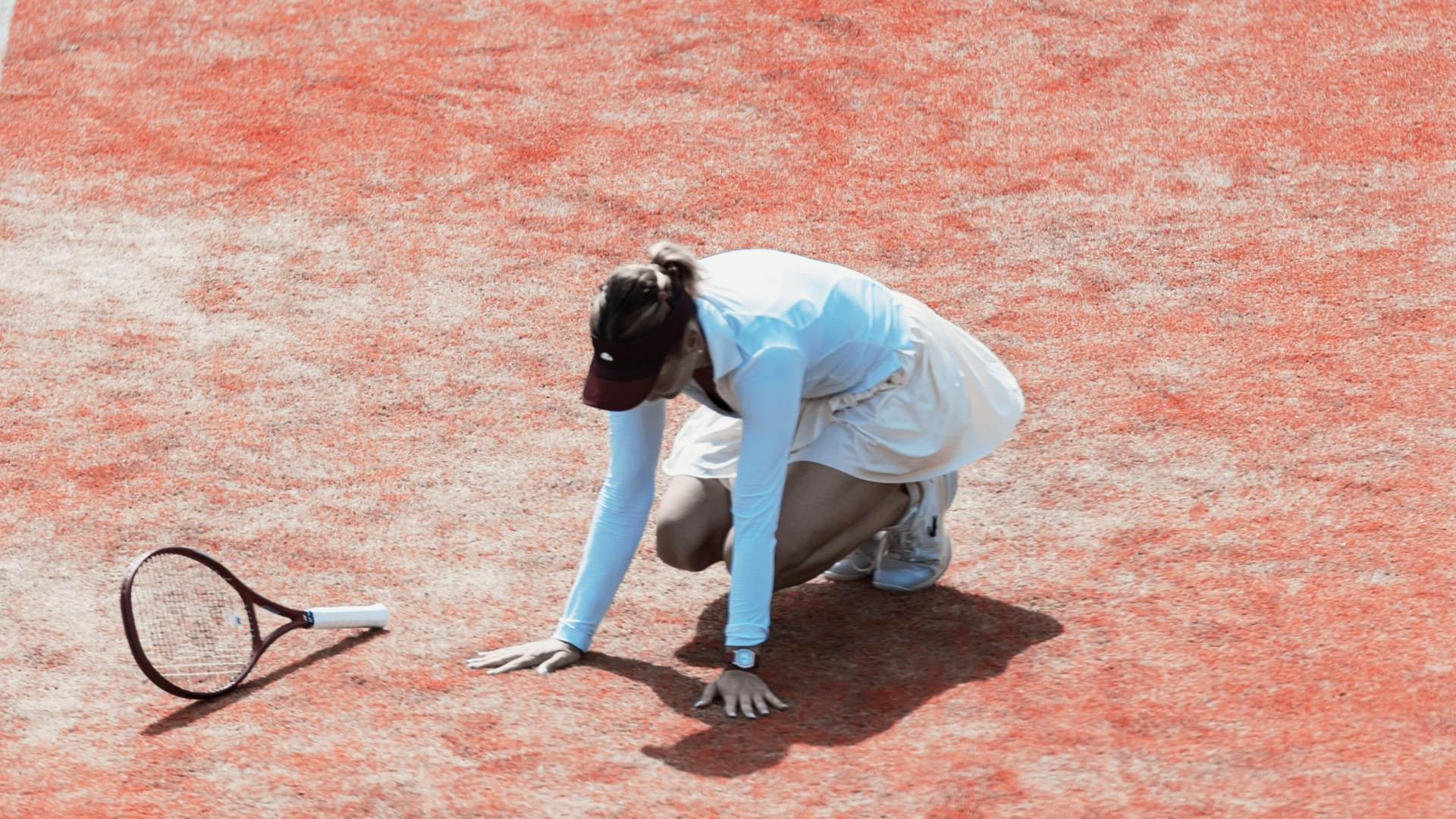 Private debt has invested in women's tennis - image shows a tennis player on her hands and knees, racquet on the ground