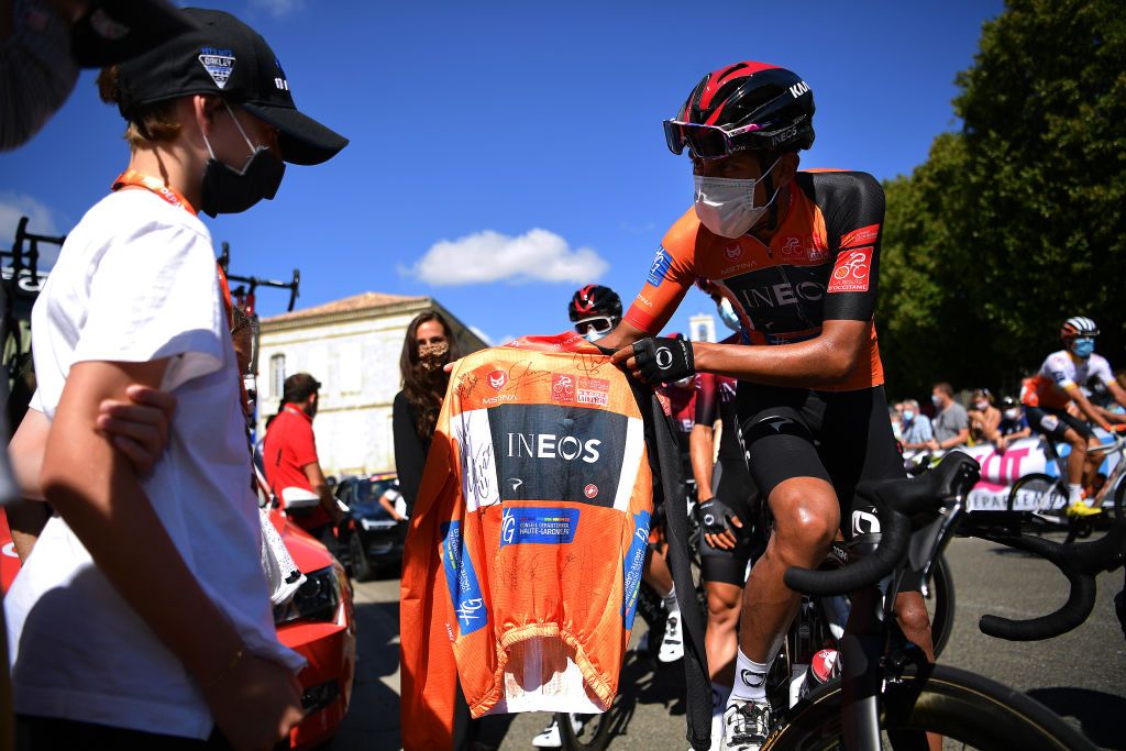 ROCAMADOUR FRANCE AUGUST 04 Start Start Tribute to Nicolas Portal of France Team Ineos former Sports Director Magalie Portal wife and Lenny Portal son Egan Bernal of Colombia and Team Ineos Orange Leader Jersey Fans Public Mask Covid Safety Measures Lectoure Village during the 44th La Route dOccitanie La Depeche du Midi 2020 Stage 4 a 195km stage from Lectoure to RocamadourCauvaldorLot 295m RouteOccitanie RDO2020 on August 04 2020 in Rocamadour France Photo by Justin SetterfieldGetty Images