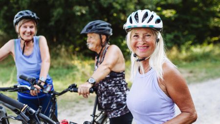 a senior woman riding a bike