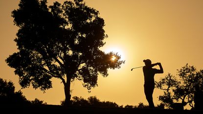 A silhouette of a golfer playing a shot on the European Tour