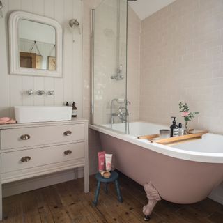 Bathroom with pink roll-top bath, pink metro tiles, wall panelling, upcycled vanity unit and counter top basin