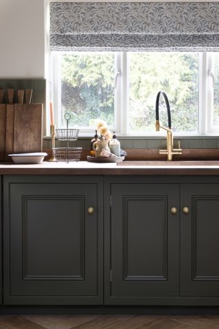 dark green inframe wooden kitchen with black AGA range cooker