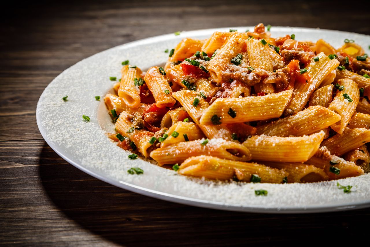 White plate of vegetarian bolognese with dusting of cheese