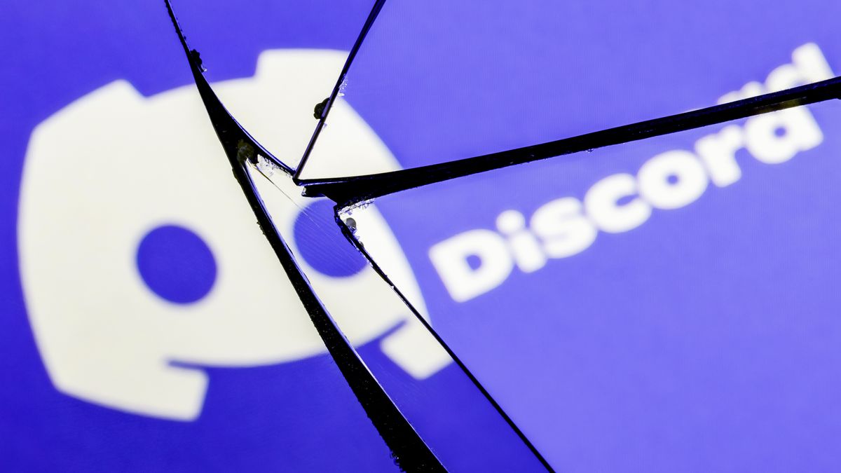 The Discord logo shown on a shattered glass screen.