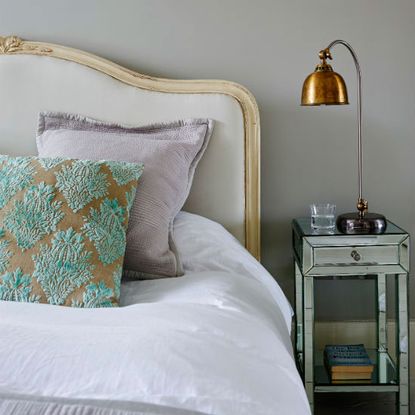 bedroom with bedside table bed and copper lamp