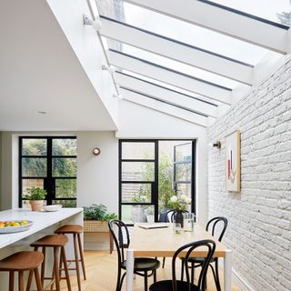 kitchen extension with white wall and dining table and chairs