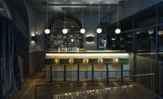 Dark bar with green velvet bar stools