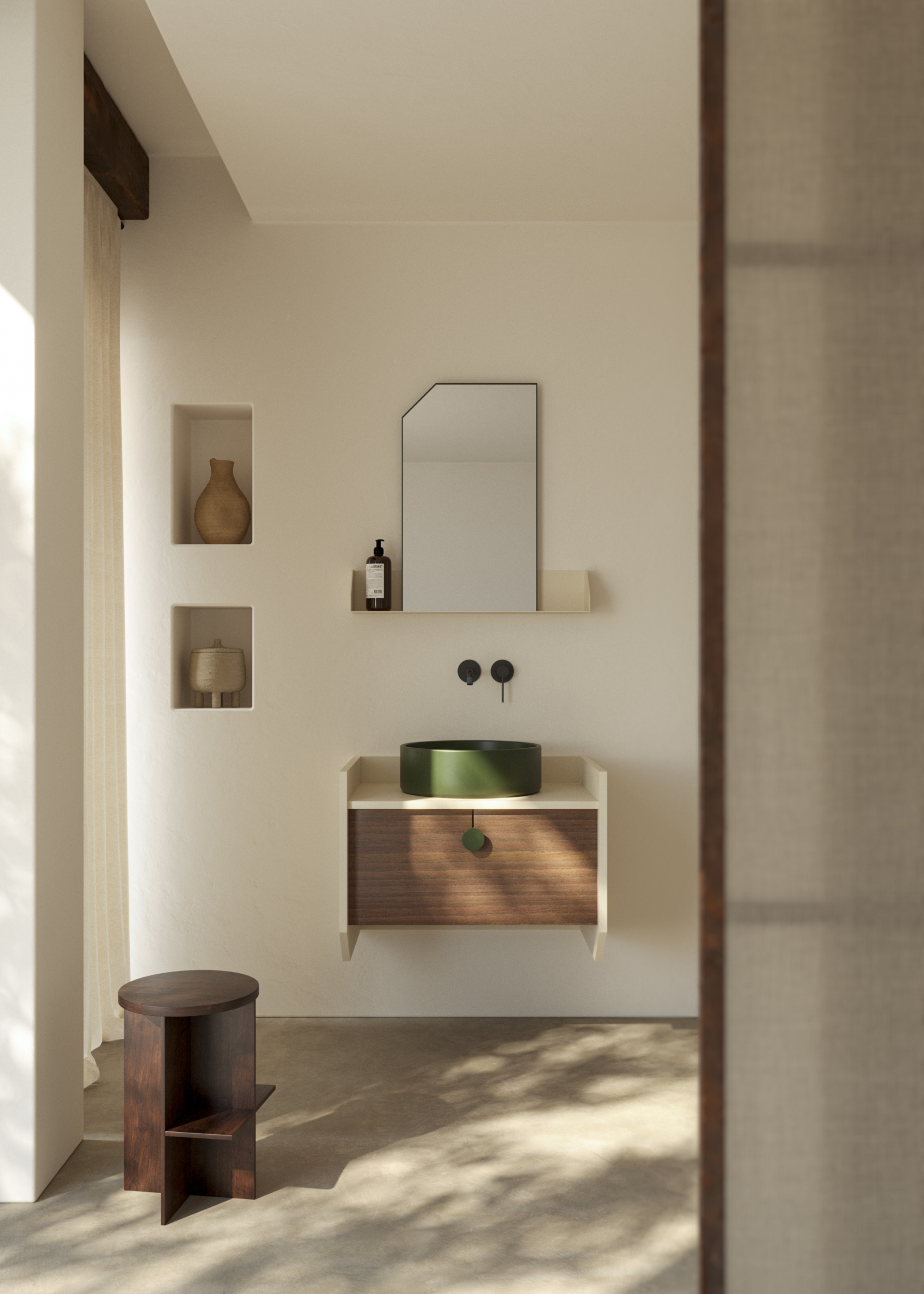 A modern sleek spa-like bathroom with a dark wooden vanity drawer, green circular basin on top and black hardware. There ae two recessed niches to the left to house decorative objects and a dark wooden stool by the window where natural light is dappling through