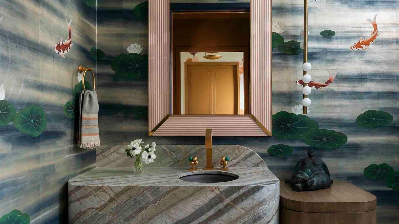 bathroom with floating marble vanity, koi pond mural wallpaper, gold mirror, timber side table, and floating pendant light on one side