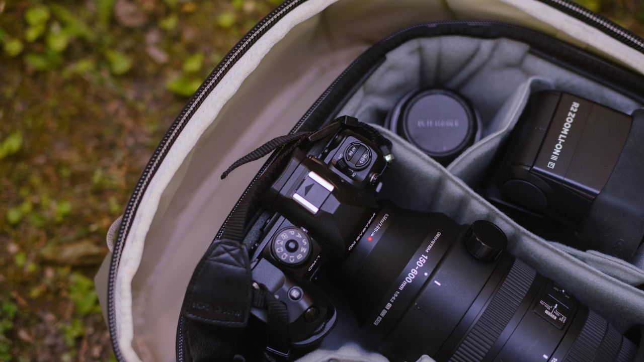 The Peak Design Travel 2-in-1 Backpack outdoors used by a photographer