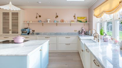 Pink kitchen with a noisette worktop and backsplash
