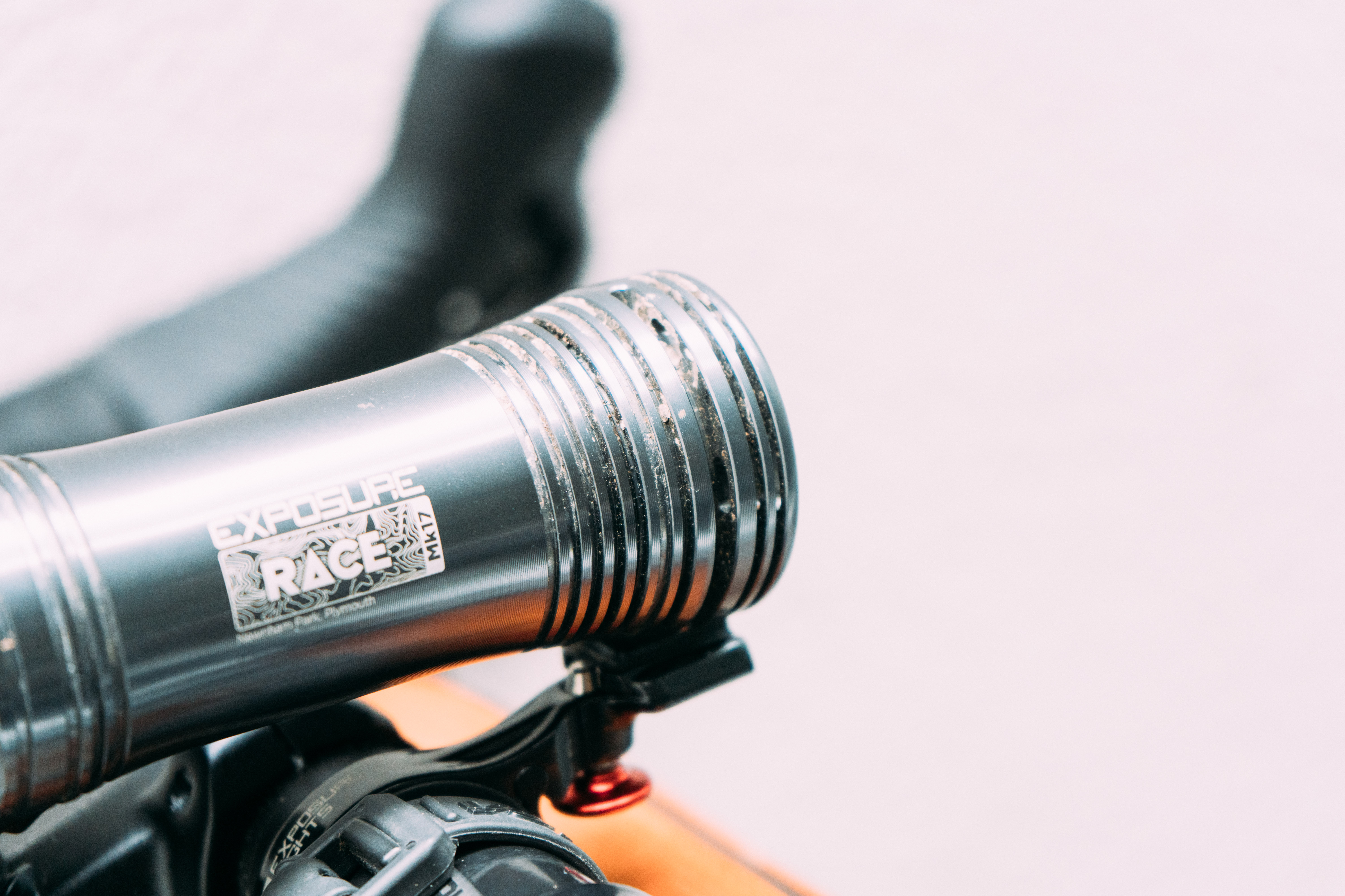 A detail shot of the machined cooling fins of a grey bike light