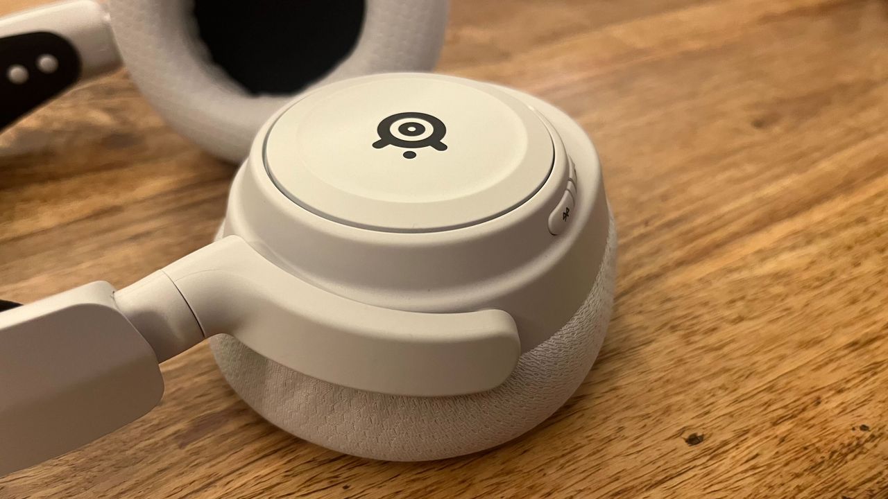 The SteelSeries Arctis Nova 7X Wireless on a wooden surface.