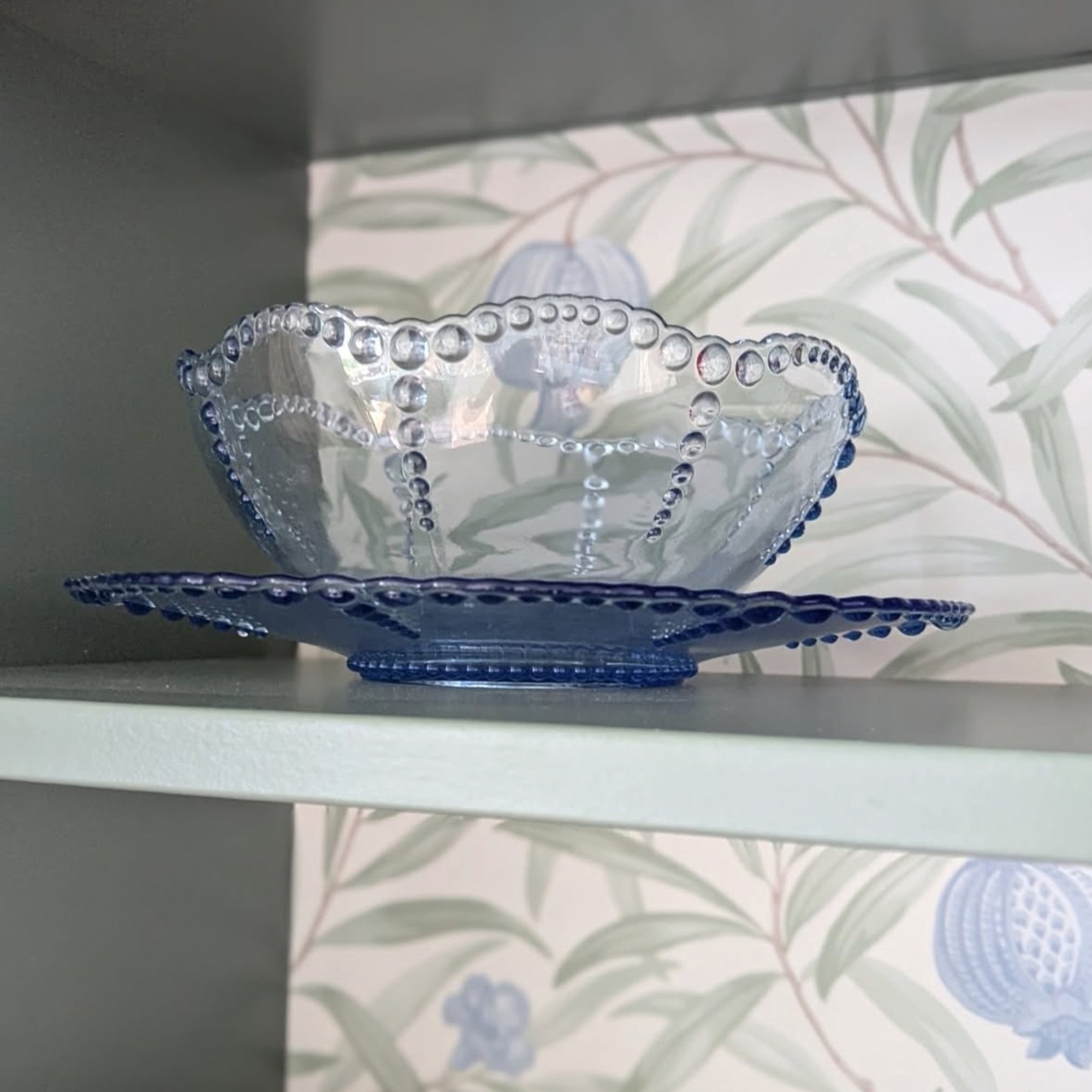 shelving with wallpaper behind it