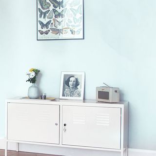 room with blue walls and white cabinet