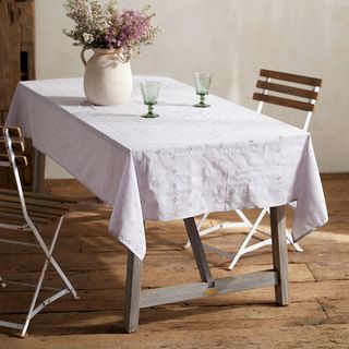 lilac tablecloth with eyelet detail draped over a table