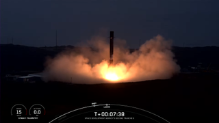 A SpaceX rocket lands at a landing pad in silhouette