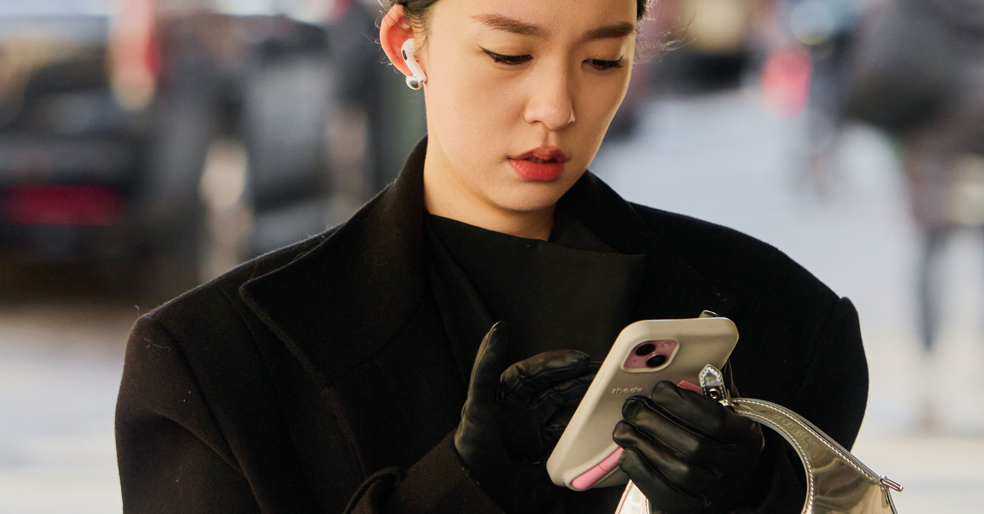 a woman wears a black coat