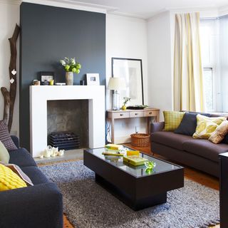 white living room with grey chimney breast and leather sofas