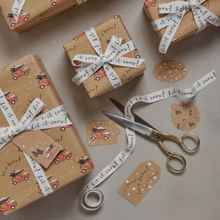 christmas gifts wrapped in brown paper with white ribbon
