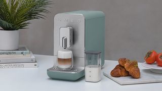 Smeg BCC13 coffee machine on kitchen counter with pastries