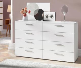 Wayfair white dresser with trinkets on top, set against a gray bedroom wall.