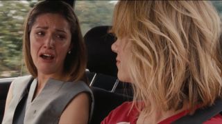 Rose Byrne crying and Kristen Wiig looking at her in Bridesmaids.