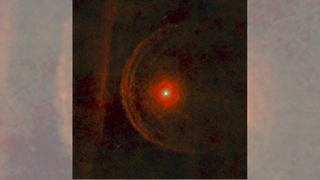 We see the red star Betelgeuse surrounded by rings of hazy red material